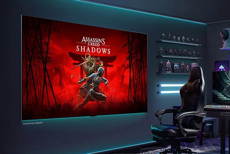 a gaming room with a computer desk and a chair and a big lg g5 tv on the wall