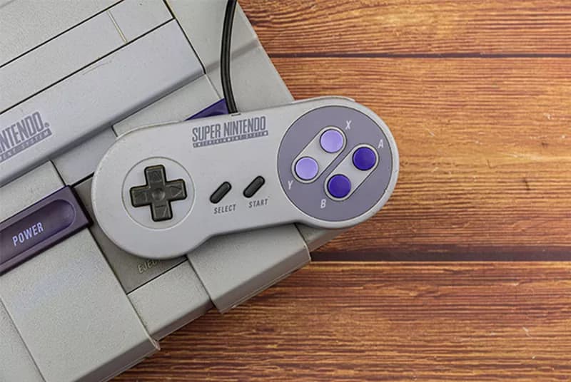 a nintendo game controller sitting on top of a nintendo game system